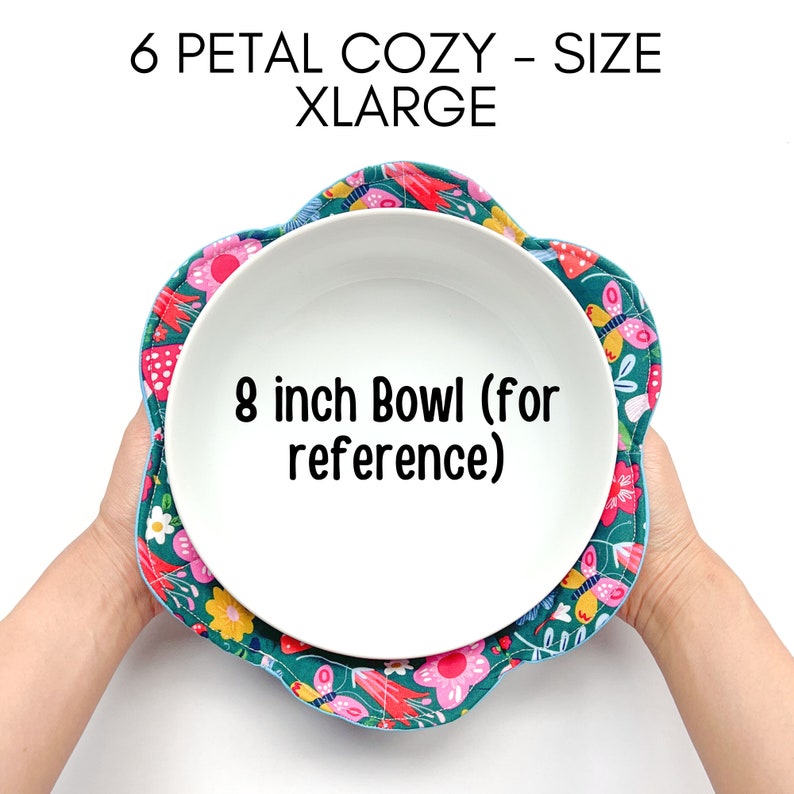 May include: A teal blue 6 petal bowl cozy with a floral print in pink, yellow, and green. The cozy is designed to fit an 8 inch bowl.  6 PETAL COZY - SIZE XLARGE