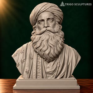 May include: A monochromatic grey bust sculpture of a person with a full beard and moustache, wearing a wrapped turban and a draped garment adorned with fleur-de-lis patterns. The figure features detailed facial expressions and sits on a base.