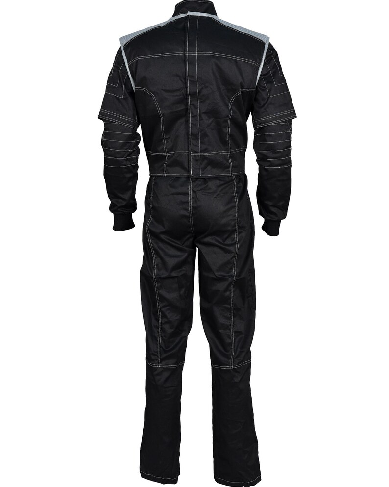 May include: A black racing jumpsuit featuring long sleeves with ribbed cuffs, a high collar, and light-colored contrast stitching throughout. The garment includes grey shoulder panels and a vertical zipper closure running down the center back.