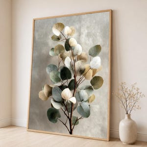May include: A framed vertical wall art print featuring a botanical illustration of a eucalyptus branch with rounded leaves in shades of sage green, muted blue, and soft beige against a textured, light gray background with a wooden frame.