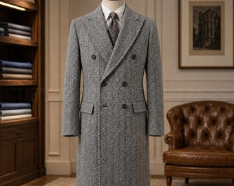 May include: A double-breasted overcoat in a grey and white herringbone pattern, featuring a wide peak lapel, six front buttons, two flap pockets, and long sleeves, displayed on a mannequin with a white collared shirt and a dark patterned tie.