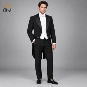 May include: A black tailcoat tuxedo featuring a white waistcoat, a white dress shirt with a wing collar, and a white bow tie. The jacket has satin lapels and double-breasted buttons. The ensemble includes matching black trousers and black dress shoes.