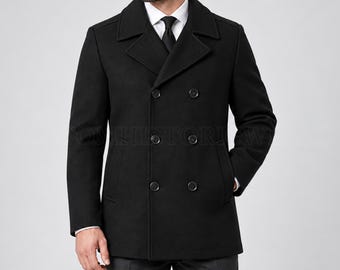 May include: A black double-breasted pea coat featuring a wide notched lapel, six front buttons arranged in two vertical rows, and two side pockets. The coat is worn over a white collared shirt with a black necktie, showcasing a structured fit.
