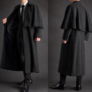 May include: A charcoal gray floor-length overcoat featuring a detachable shoulder cape, a classic collar, and long sleeves. The coat is worn over a matching charcoal gray suit jacket, a white collared shirt, a black tie, and black trousers.