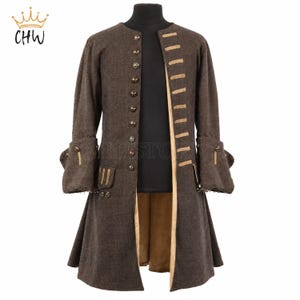 May include: A brown long-sleeved coat featuring a row of metallic buttons on the right side, tan decorative trim on the left side, and wide cuffs with button accents. The coat has a tan lining and a structured collarless neckline design.
