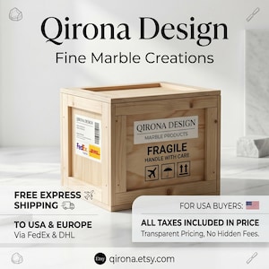 May include: A light-colored wooden shipping crate with a flat top and reinforced edges. The side features a white label with the text Qirona Design Marble Products, Fragile Handle With Care, and three black icons representing air, rain, and stacking.