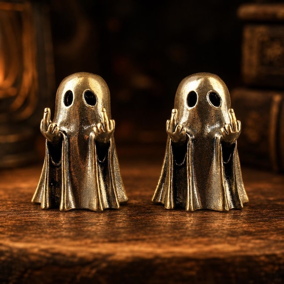 A handmade, hand-molded ghost flipping you off — vintage statue energy meets maximum sarcasm in a single desk ornament.