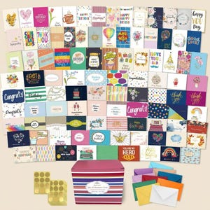 May include: A collection of assorted greeting cards featuring various designs, colors, and text, including birthday, sympathy, and congratulatory themes. A large striped storage box, gold circular stickers, and colorful envelopes are included.