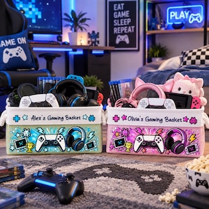 May include: Two rectangular fabric storage baskets for gaming accessories. The left basket is light green with the text Alex's Gaming Basket, while the right is pink with Olivia's Gaming Basket. Both feature printed game controllers and headsets.