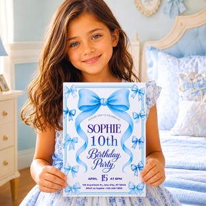 May include: A rectangular birthday party invitation card featuring a large blue bow at the top and smaller blue bows along the border. The text reads: Please join us celebrate Sophie 10th Birthday Party April 15 at 6pm 123 Anywhere St., Any City, ST 12345 RSVP to Sophie +123-456-7890.