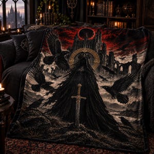 May include: A rectangular throw blanket featuring a dark, gothic-inspired print of a cloaked figure standing before a ruined castle under a red sky. The design includes a central sword, multiple black ravens in flight, and a golden circular emblem.