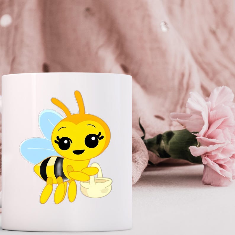 May include: A white ceramic mug featuring a cartoon illustration of a yellow and black bee with light blue wings. The bee has large black eyes, long eyelashes, and is holding a small, light-colored basket in its hands against a plain white background.
