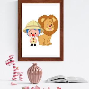 May include: A framed wall art print featuring a cartoon explorer with blue hair and a red nose wearing a tan safari hat and outfit, standing next to a winking lion with its tongue out. The frame is dark brown wood with a simple rectangular design.