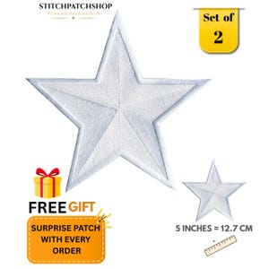 May include: A set of two white star-shaped embroidered patches. The larger star measures 5 inches across. The image includes text reading STITCHPATCHSHOP, Set of 2, and FREE GIFT SURPRISE PATCH WITH EVERY ORDER, along with a ruler graphic.