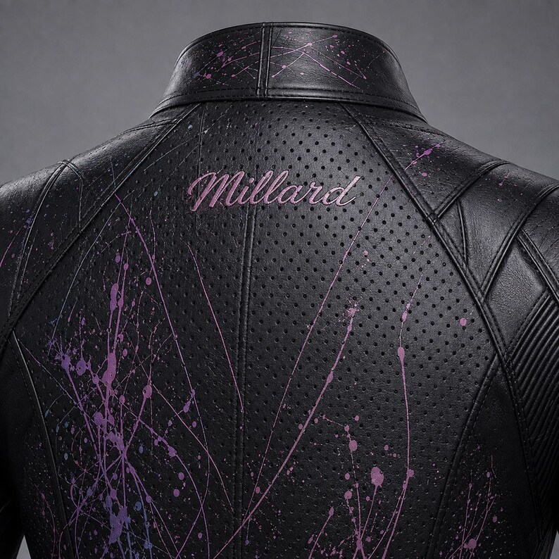May include: A black perforated leather jacket featuring a high collar and structured paneling. The back displays the word Millard embroidered in pink script, accented by a vibrant purple and pink paint splatter design across the surface.