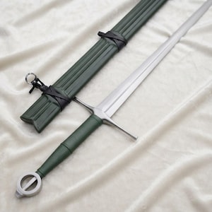 May include: A longsword with a double-edged steel blade, a crossguard, and a green grip. The pommel is a circular metal ring. The matching green scabbard features vertical ridges and is secured with black leather cord wrappings at the top.