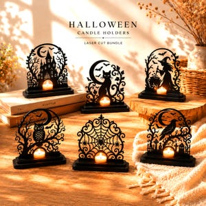 May include: A set of six black laser-cut candle holders featuring Halloween-themed silhouettes including a haunted house, a cat, a witch, an owl, a spider web, and a raven, each with a small circular base and a lit tea light candle.