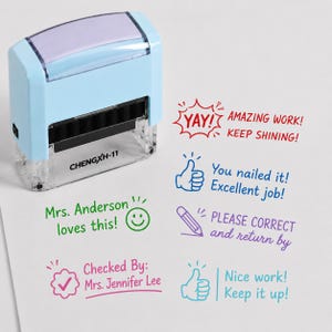 May include: A light blue self-inking stamp with a clear base labeled CHENGXH-11. The stamp is shown next to various colorful ink impressions including phrases like YAY! AMAZING WORK! KEEP SHINING!, You nailed it!, Mrs. Anderson loves this!, PLEASE CORRECT and return by, Checked By: Mrs. Jennifer Lee, and Nice work! Keep it up!.