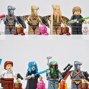 May include: A collection of Star Wars themed plastic minifigures including various alien characters, a Jedi in black robes, a bounty hunter in green armor, and several small droid figures in red, pink, and white colors, all standing on a white surface.