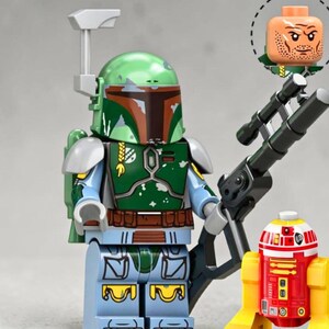 May include: A Boba Fett LEGO minifigure with a green helmet, green chest armor, and light blue limbs, holding a black blaster rifle. Beside it stands a small red and yellow droid. An alternate human head with a scarred face is shown above.