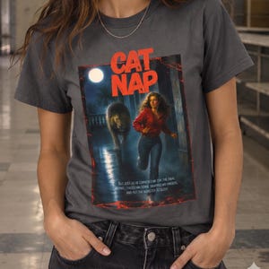 Cat Nap poster art T-shirt | woman running from giant cat, moonlit horror scene
