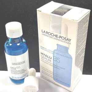 May include: A blue glass bottle of La Roche-Posay Hyalu B5 serum with a white dropper cap and its matching white and blue cardboard box. The packaging features the text La Roche-Posay Laboratoire Dermatologique, Hyalu B5 Serum, and 30 ml.