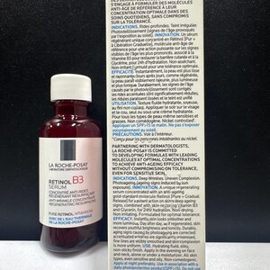 May include: A bottle of La Roche-Posay Retinol B3 serum with a white cap and a white label featuring black and red text, positioned next to its rectangular cardboard packaging box which displays detailed product information in French and English.