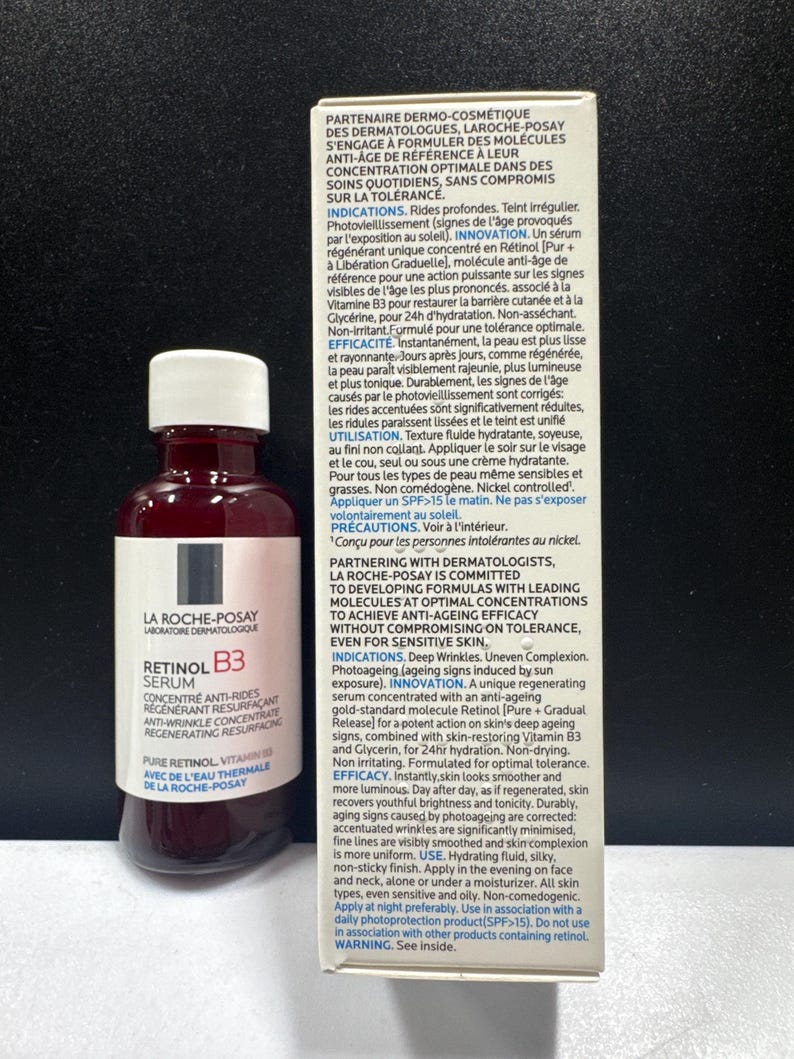 May include: A bottle of La Roche-Posay Retinol B3 serum with a white cap and a white label featuring black and red text, positioned next to its rectangular cardboard packaging box which displays detailed product information in French and English.