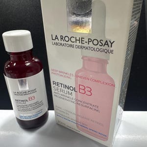 May include: A La Roche-Posay Retinol B3 serum bottle and its matching white cardboard box. The bottle is dark red with a white label. The box features the brand name, product name, and text including Deep Wrinkles, Uneven Complexion, and 30ml.