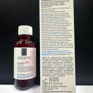 May include: A 30ml bottle of La Roche-Posay Retinol B3 serum with a white cap and a white label featuring black and red text, positioned next to its rectangular cardboard packaging box which displays detailed product information and ingredients.