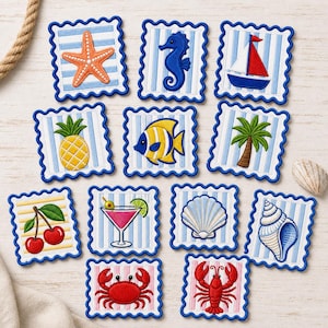 May include: A collection of eleven square fabric patches with scalloped blue edges, featuring embroidered nautical and tropical designs including a starfish, seahorse, sailboat, pineapple, fish, palm tree, cherries, cocktail, and various seashells.