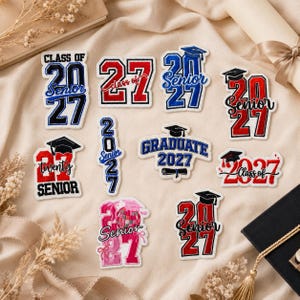 May include: A collection of eleven embroidered patches featuring graduation themes for the class of 2027. The designs include various combinations of the numbers 2027, the words Senior, Class of, and Graduate, along with graduation caps and diplomas.