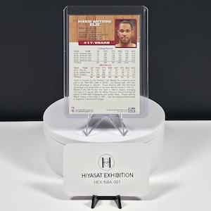 May include: A 1994 Skybox basketball trading card of Mario Antoine Elie, number 343, encased in a clear plastic holder. The card back displays biographical data, college and NBA career statistics, and a small portrait of the athlete.