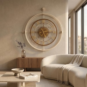 May include: A large circular wall clock featuring a compass design with a white metal frame, a dark wood inner ring, and gold-colored hands. The clock face displays Roman numerals and cardinal directions including N, S, E, and W in a central star pattern.