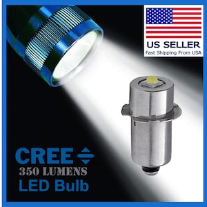 May include: A silver Cree LED bulb with a yellow light, rated for 350 lumens. The bulb is shown in a close-up view, with a flashlight beam shining on it.