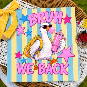 May include: A rectangular sign with vertical light blue and yellow stripes featuring a white duck wearing pink sunglasses and a yellow backpack while holding a pink tumbler and blowing a pink bubble. The text BRUH WE BACK is in pink.