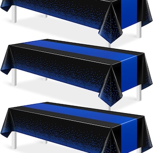 May include: Three rectangular plastic tablecloths featuring a solid royal blue center stripe flanked by black side panels. The black sections are decorated with a gradient pattern of small blue dots that become denser toward the bottom edges.