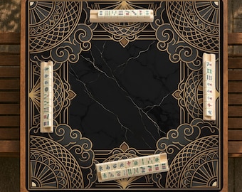 May include: A square mahjong table featuring a black marble-patterned center surface surrounded by a decorative border with gold fan and cloud motifs. Four wooden tile racks are positioned along the edges, each holding a set of mahjong tiles.