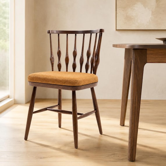 Solid walnut dining chair with clean Scandinavian lines — the kind of handcrafted furniture piece you buy once and pass down, not something you'd ever find flatpacked.