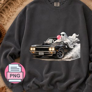 May include: A charcoal gray crewneck sweatshirt featuring a graphic of a white ghost wearing sunglasses and blowing a pink bubblegum bubble while driving a black muscle car. The car has a license plate that reads BOO and is surrounded by smoke.