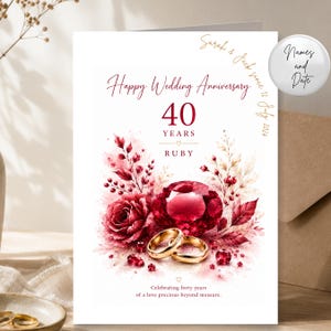 May include: A white wedding anniversary card featuring the text Happy Wedding Anniversary, 40 YEARS, and RUBY. The design includes a large red gemstone, two gold rings, and watercolour-style red roses and foliage. The text Sarah & Jack since 12 July 2024 is printed in the corner, with additional text at the bottom.