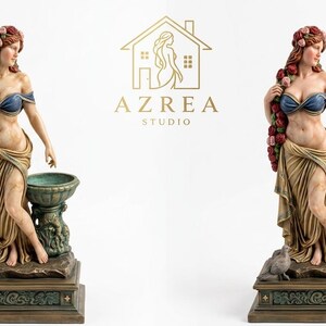 May include: Two identical statues of a woman with reddish hair adorned with roses, wearing a blue top and tan draped skirt, standing beside a green basin on a rectangular base with a bird, featuring the gold text AZREA STUDIO in the centre.