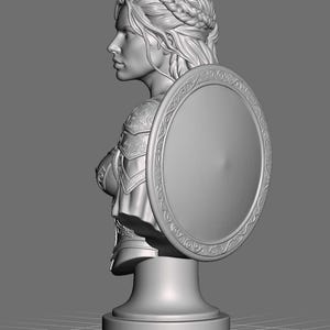 May include: A grey 3D digital model of a bust featuring a person with braided hair, wearing ornate armor and holding a large circular shield with an intricate border pattern. The sculpture is mounted on a simple pedestal base against a plain background.