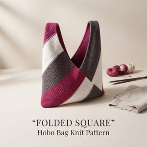 May include: A knit hobo bag featuring a geometric pattern of diagonal stripes in magenta, white, and dark gray. The text "FOLDED SQUARE" Hobo Bag Knit Pattern is printed below the bag, which is accompanied by yarn and knitting needles.