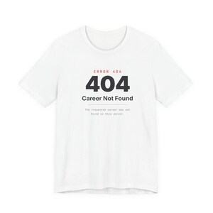 Peut inclure: Un t-shirt blanc &agrave; manches courtes avec une impression graphique noire et rouge indiquant ERROR 404, 404, Career Not Found, et The requested career was not found on this server dans une police sans empattement centr&eacute;e sur la poitrine.