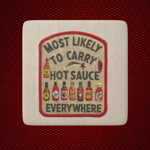 May include: A square beige fabric coaster featuring an embroidered red border and the text "MOST LIKELY TO CARRY HOT SAUCE EVERYWHERE" in dark green. The design includes illustrations of various hot sauce bottles and small chili peppers.