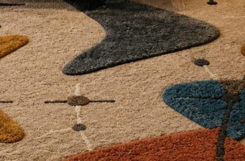 May include: A textured area rug featuring a beige background with a pattern of abstract shapes in dark gray, mustard yellow, blue, and burnt orange. The design includes thin white lines connecting small dark circles, creating a geometric motif.