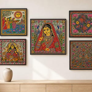 May include: A collection of five square framed wall art pieces featuring intricate Madhubani style paintings. The artworks display vibrant scenes including a central bride, a deity with tigers, a sun, fish, and a tree, all with detailed patterns.