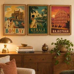 May include: Three framed rectangular wall art prints featuring travel illustrations of India. The left print shows the Gateway of India in Bombay, the center print depicts a Kerala backwater scene, and the right print displays the Hawa Mahal in Rajasthan.