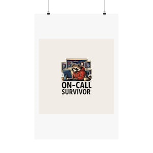 May include: A graphic print featuring a raccoon wearing a red hoodie, sitting at a desk with multiple computer monitors displaying code, a coffee cup, and the text ON-CALL SURVIVOR in bold black capital letters centered below the illustration.